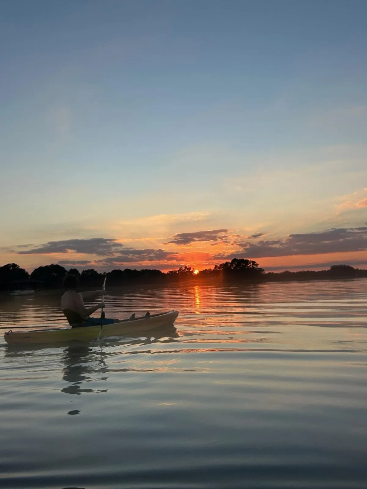 Kayaker looking at the beautiful St. Cloud lakefront sunset