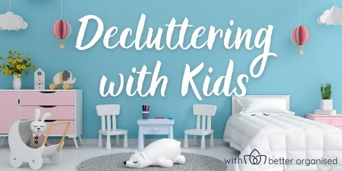 Child's bedrooms with a white bed, pink drawers, toys & a blue wall. Text reads 'Decluttering with Kids'