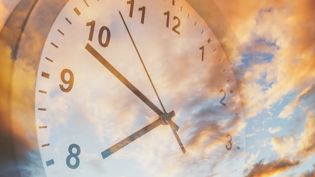 Transparent clock overlay on a golden sky, symbolizing God’s perfect timing and patience in financial journeys