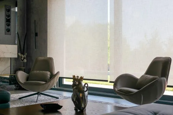 White full-height plantation shutters on a large window in a contemporary living room in Houston, TX.