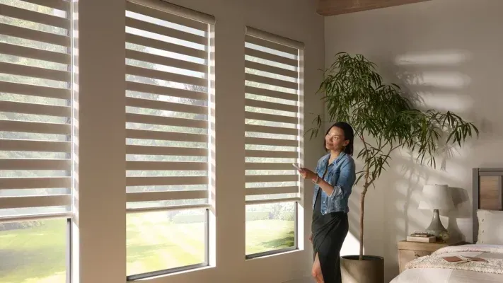  A motorized Zebra Shade being raised or lowered using a remote control.
