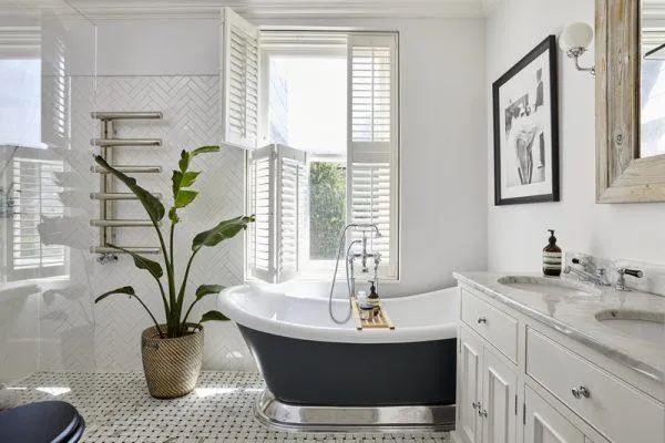 Large window fitted with tier-on-tier shutters balancing light and privacy