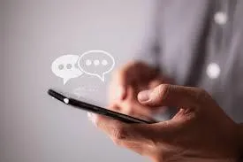 Photo of someone texting on a cell phone with their thumbs