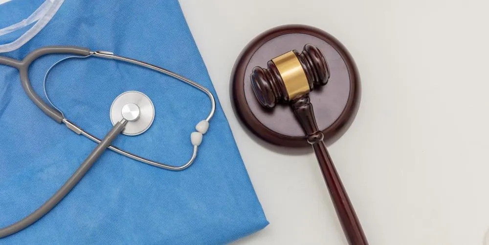 Gavel and medical documents, symbolizing healthcare compliance