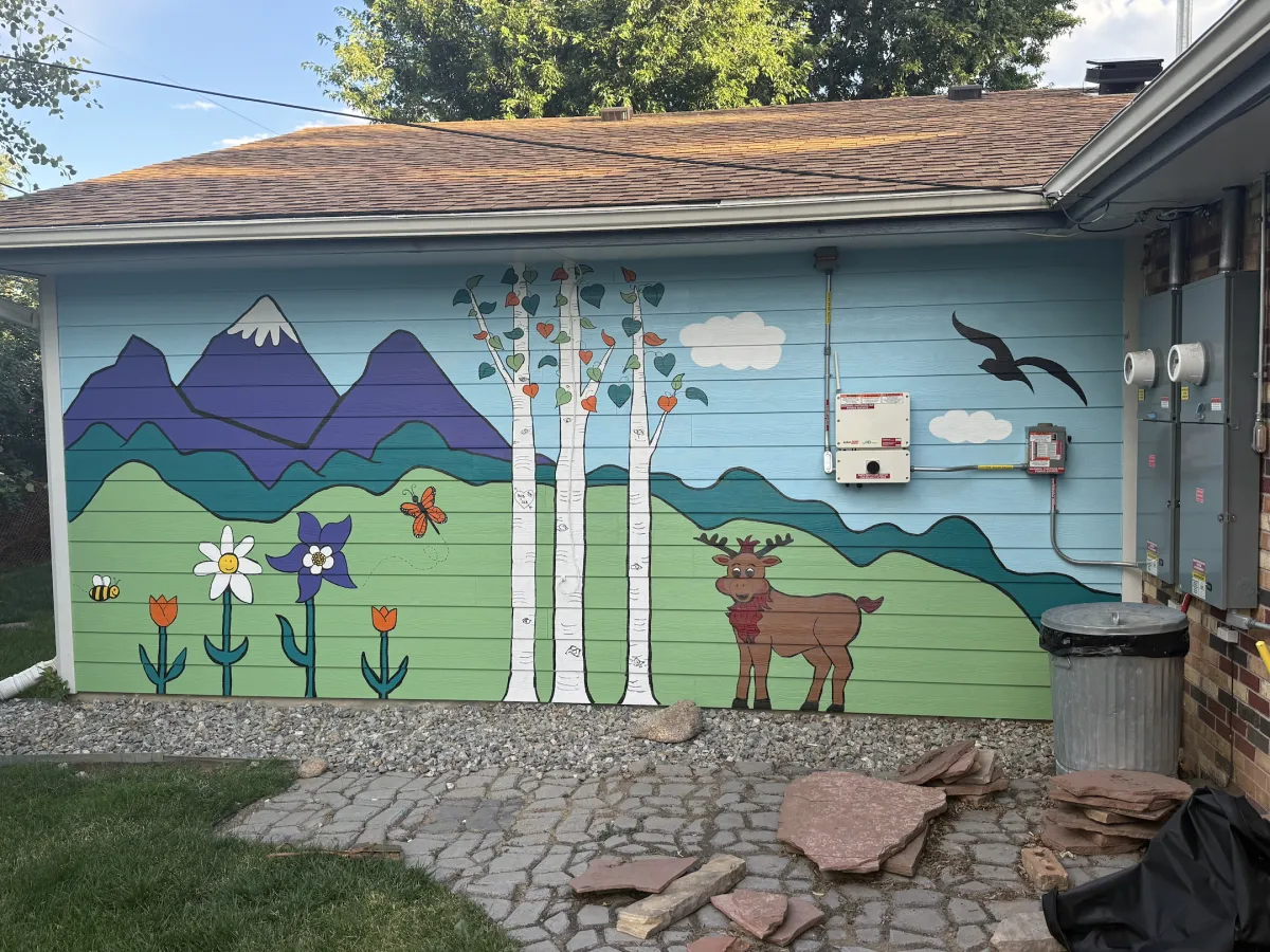 Mural showing colorado mountains, flowers, aspen trees, and a moose