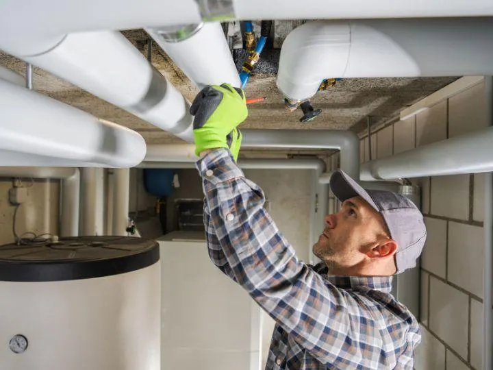 a man fixing commercial plumbing issues in anchorage