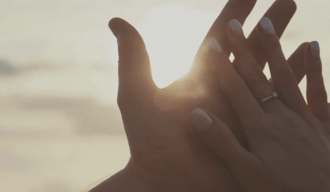 Two pairs of hands touching
