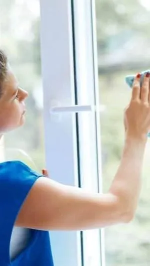 Cleaning professionals wiping down windows in a newly built home, removing construction dust and ensuring a streak-free, sparkling finish.