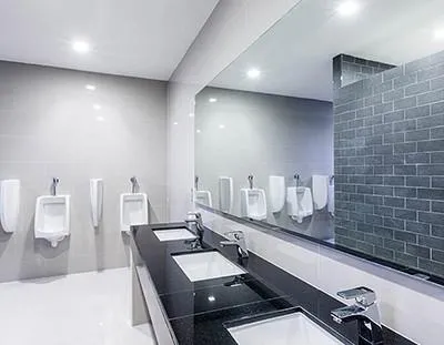 Spotless commercial bathroom with gleaming surfaces, clean floors, and well-maintained fixtures, ensuring a fresh and hygienic environment..
