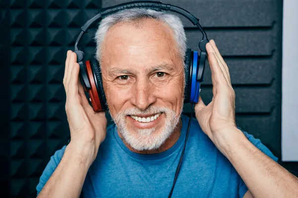 Man wearing headphones to protect his hearing in midlife