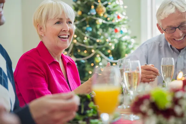 Midlife adults enjoying a festive Christmas meal together without stress or overindulgence