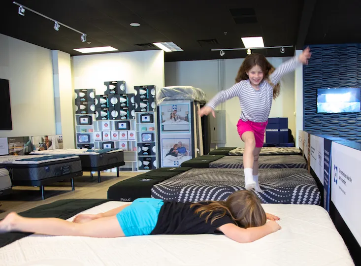 People having fun in a mattress store