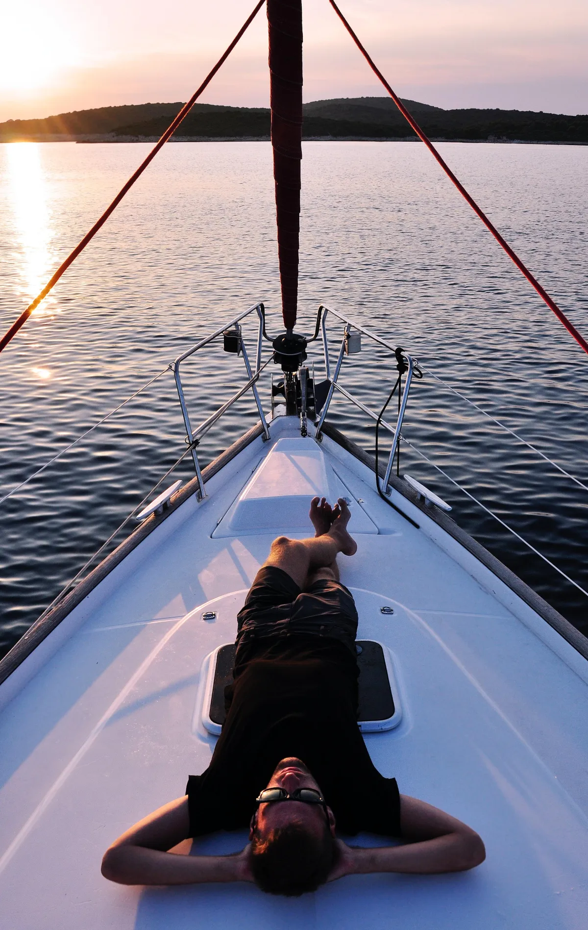 Man on yacht enjoying freedom.