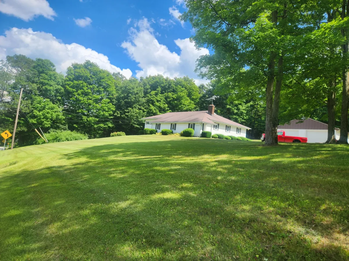 Hillside lawn and landscaping service with Altoona view