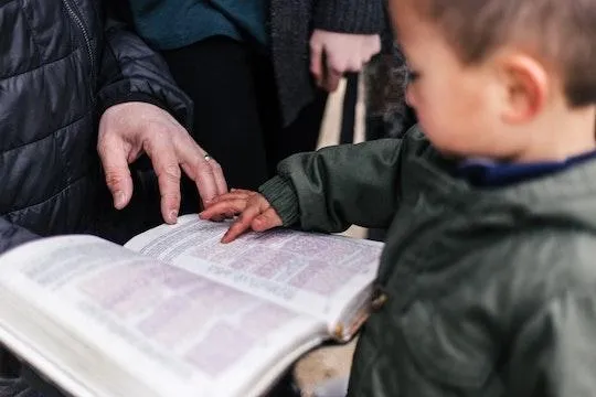 A grandparent’s hands holding a child’s hands