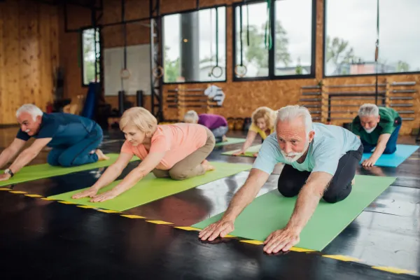 Image of seniors participating in laughter yoga exercises.