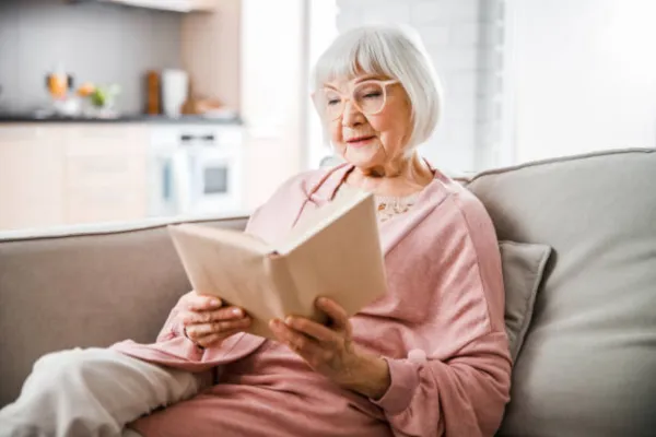 Image of a senior engaging in self-care activities, such as taking a bath, reading a book, spending time in nature, or meditating.