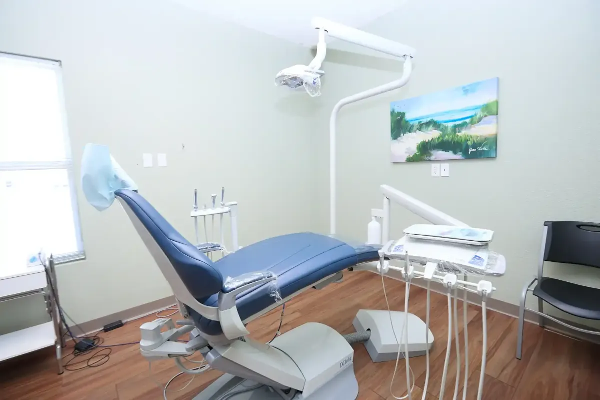 A high-tech dental treatment room featuring a comfortable blue patient chair