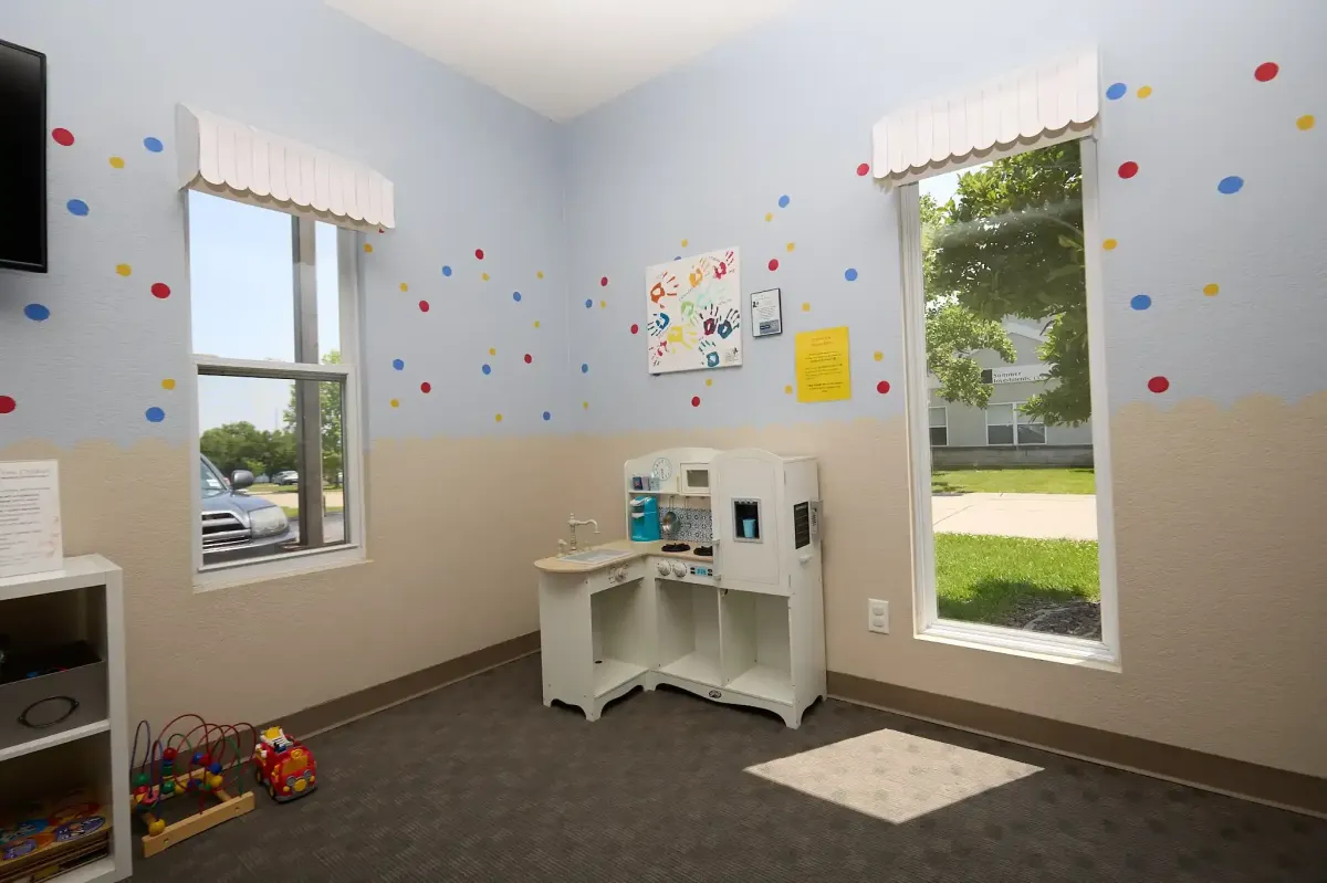 A play kitchen and activity area to keep children entertained at the dentist