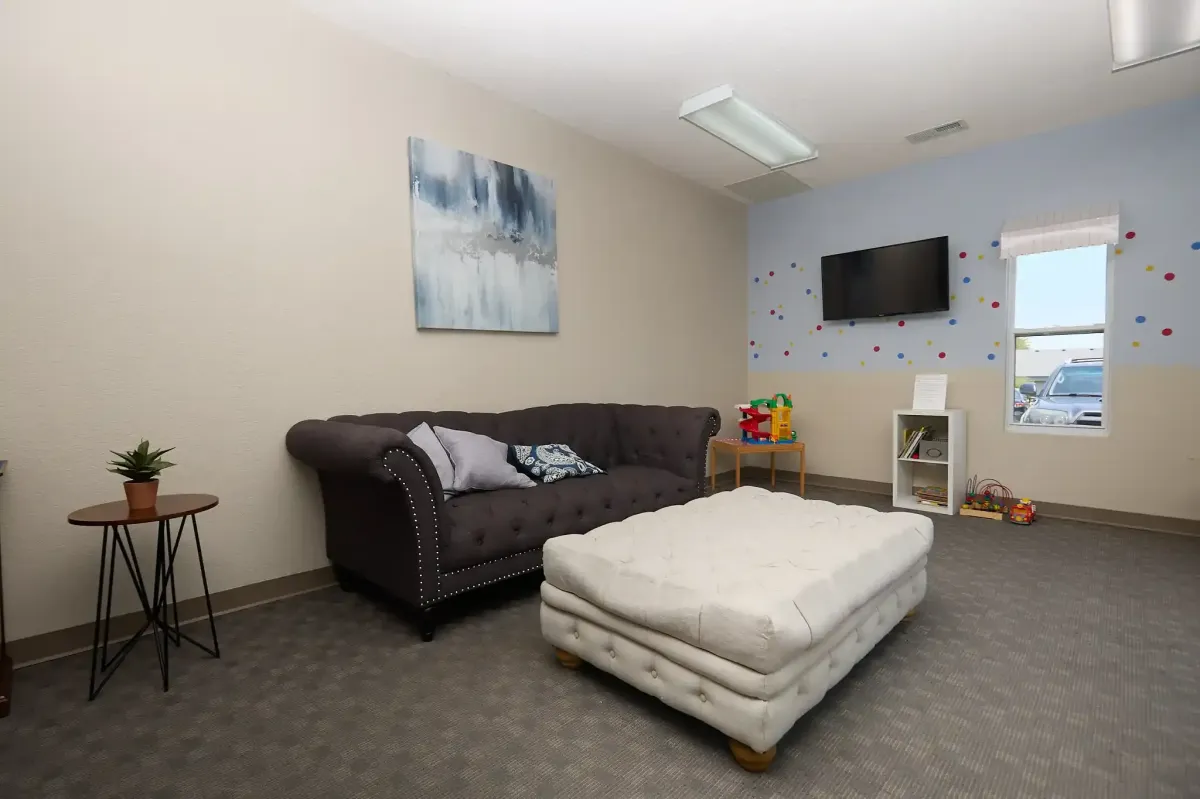 A plush sofa and relaxing seating area for patients at Cardinal Dental of St. Peters