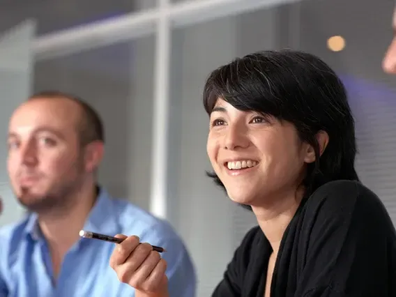 woman smiling with black pen on her hand