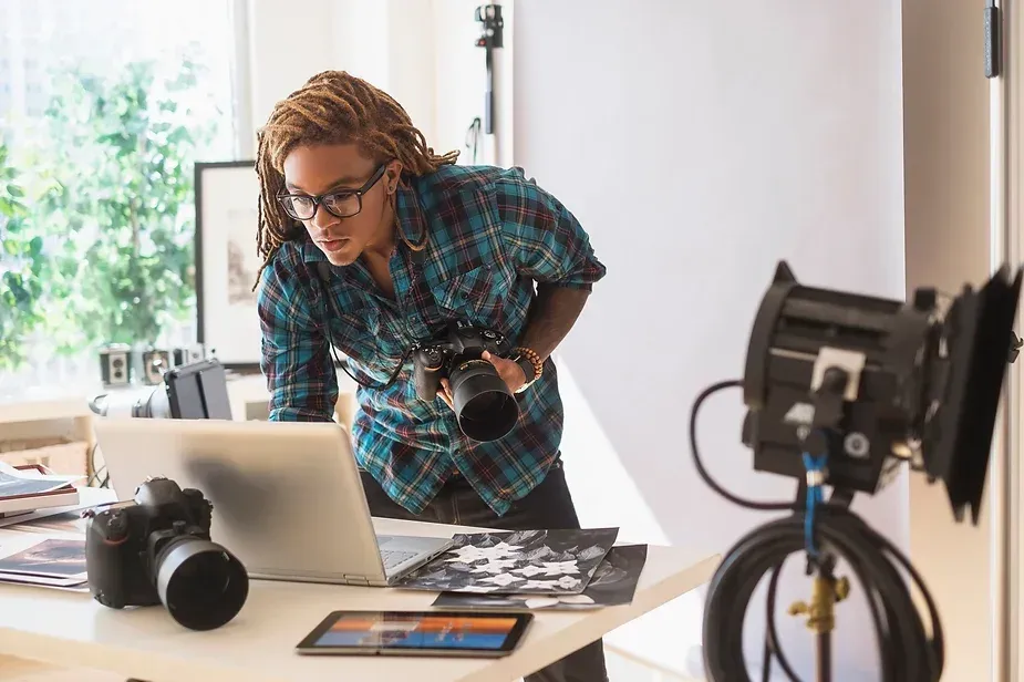A guy with a laptop and camera