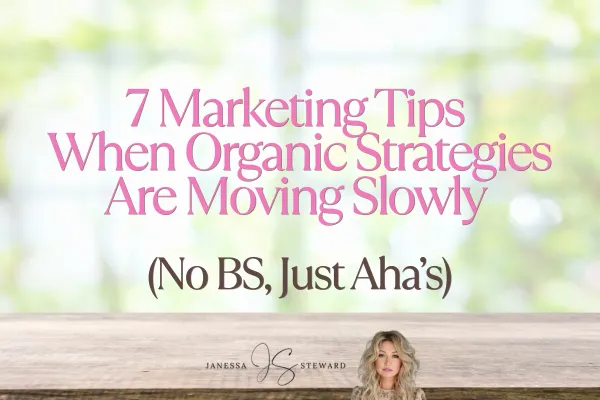 A graphic with a blurred background featuring greenery and soft light. The text in the center reads "7 Marketing Tips When Organic Strategies Are Moving Slowly (No BS, Just Aha’s)" in pink and black fonts. Below the text is a photo of Janessa Steward and her logo, with her name written in a stylish font.