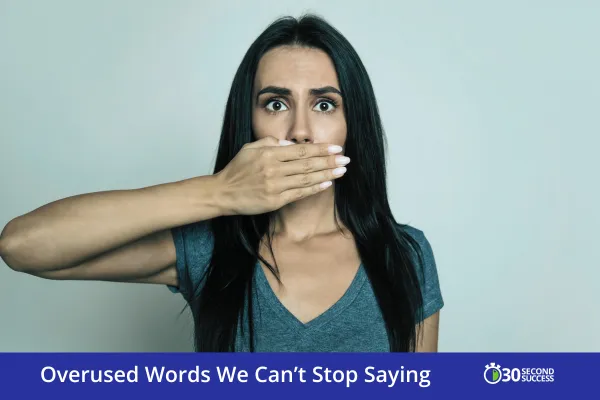 Surprised woman with long dark hair covering her mouth with one hand, symbolizing the overuse of filler words. Text overlay reads “Overused Words We Can’t Stop Saying” with the 30 Second Success logo.