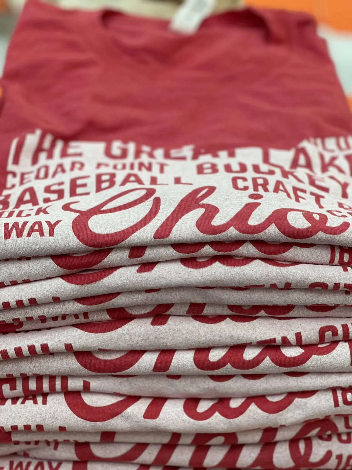 Stack of red Ohio tees printed by Cash