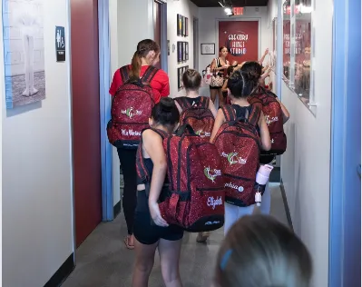 dancers with red backpacks