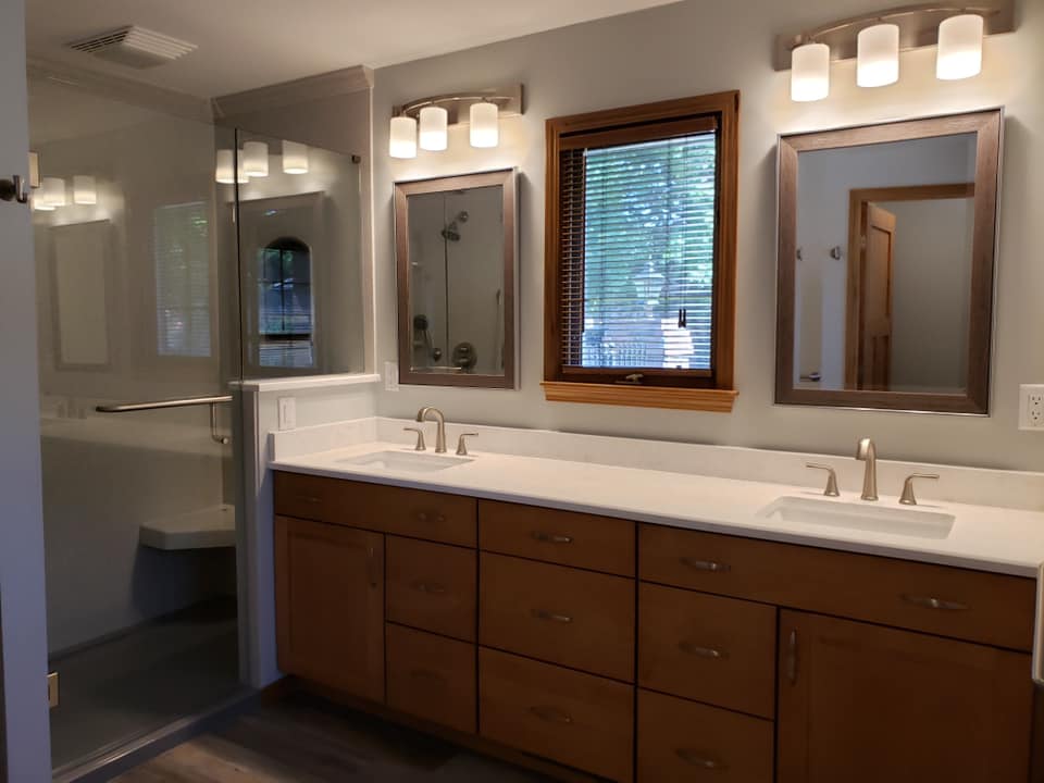Bathroom remodel with wood counters and a tiled shower with a double sink in Wichita, Kansas