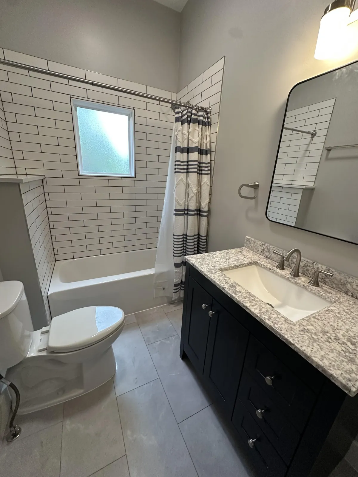 Bathroom remodel with tiled floor and shower surround in Wichita, Kansas