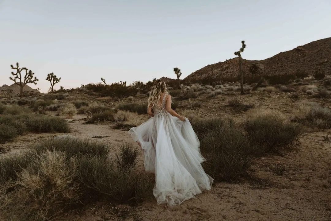 Woman standing in prayer with eyes closed, light shining behind her, symbolizing deliverance, healing, and freedom from counterfeit relationships through faith in God.