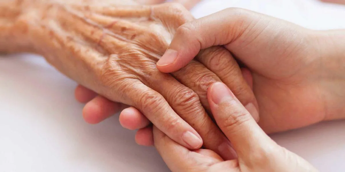 holding an elderly person's hand