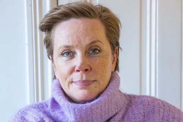Portrait of Emmely Christiansen, wellness coach and chronic illness advocate, smiling gently—capturing resilience and warmth after years of living with undiagnosed pain.