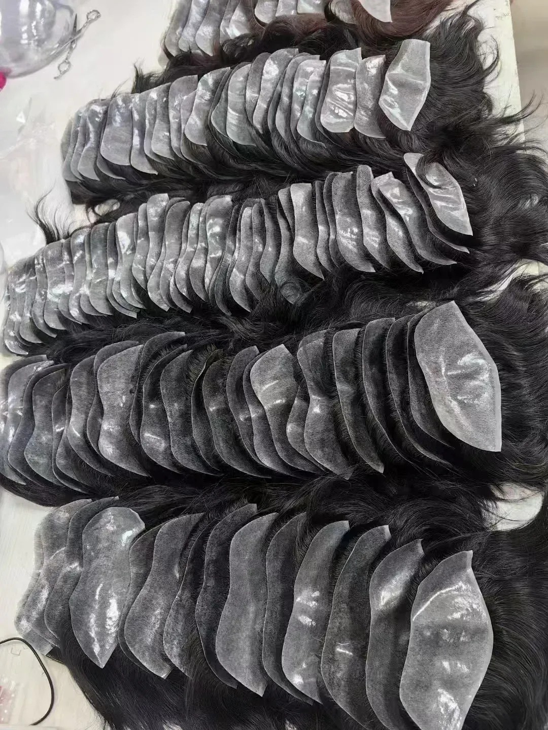Sorted human hair bundles on processing table