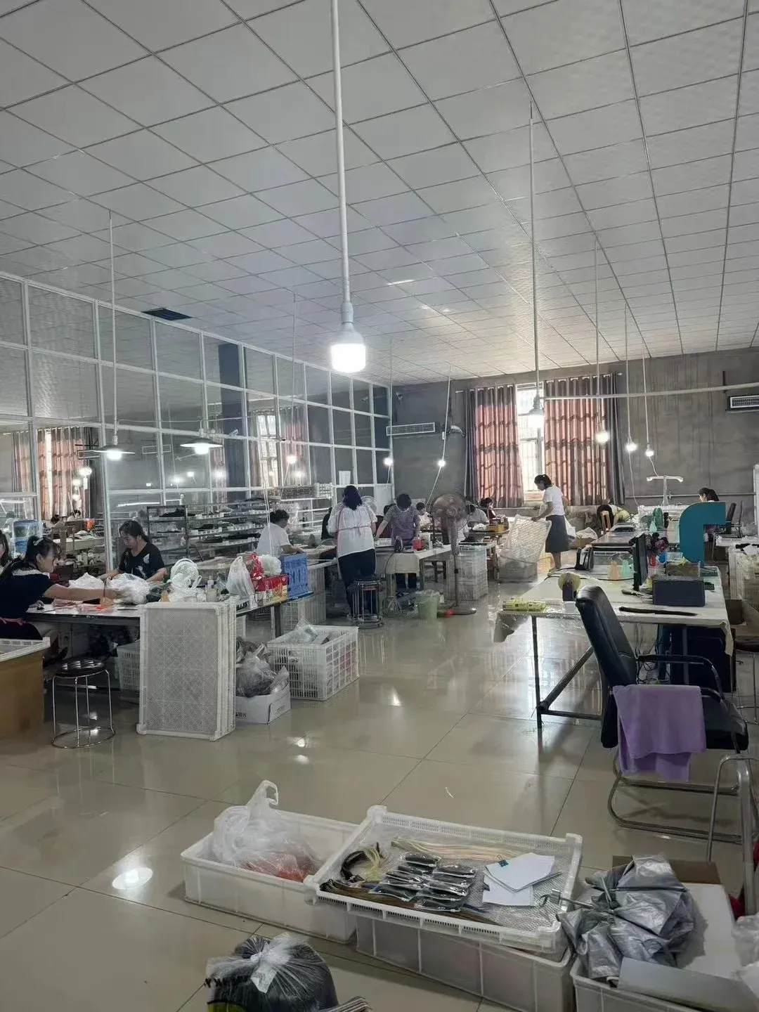 Workers preparing human hair for wig crafting on treatment tables
