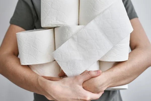 Man Holding Toilet Paper: Are Your Bowel Movements Healthy?