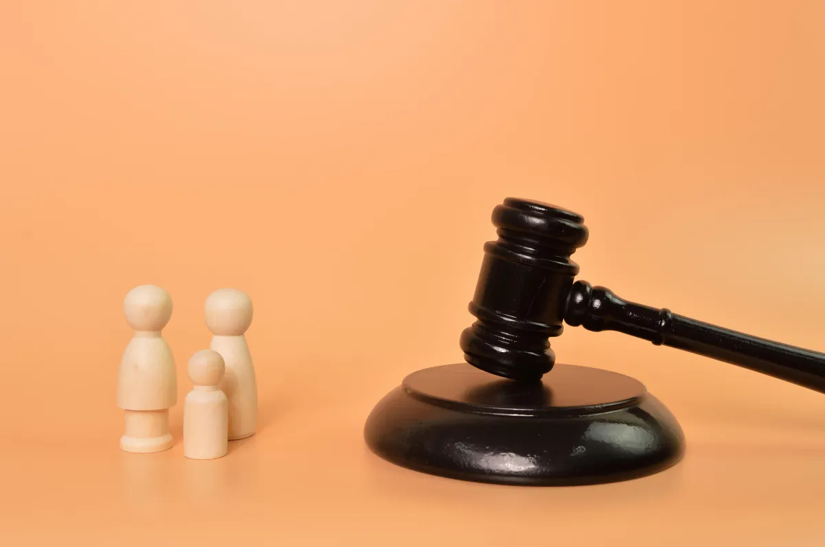gavel and wood sculpture of a family