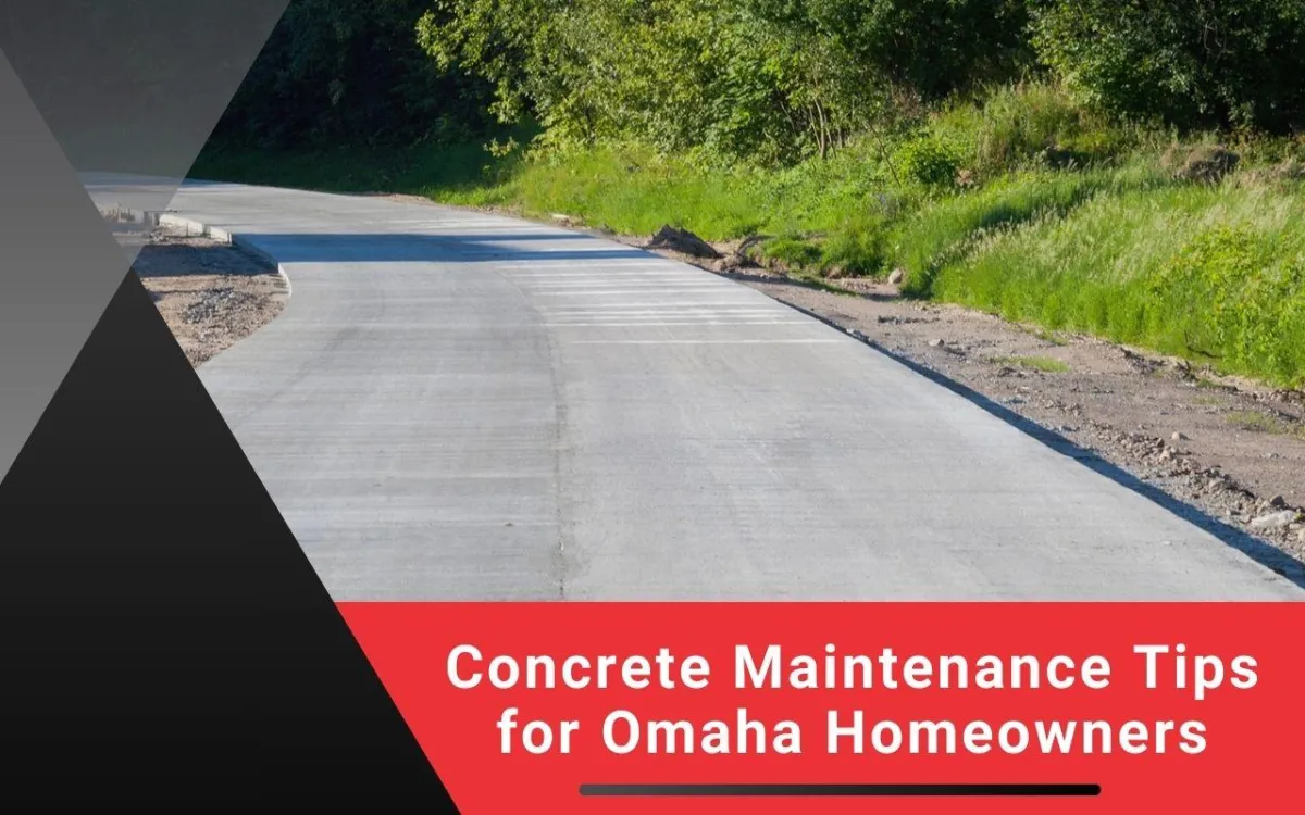 Cleaning a concrete driveway in Omaha with a pressure washer.