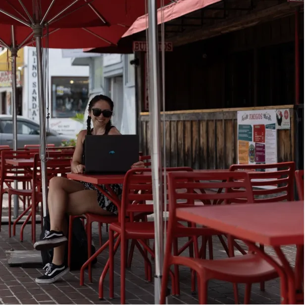 celeste sitting at cafe with laptop