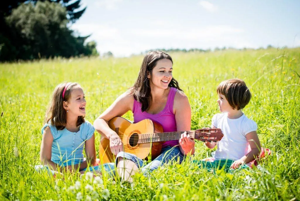 Mom playing music with children