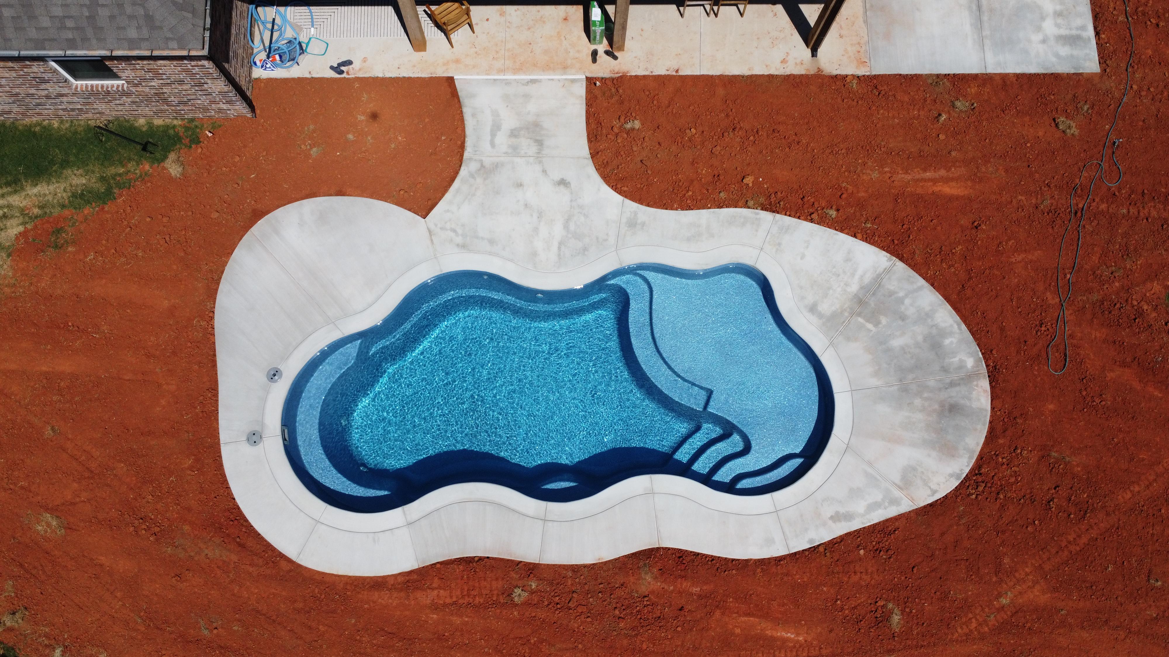 Fiberglass pool installation in Oklahoma backyard