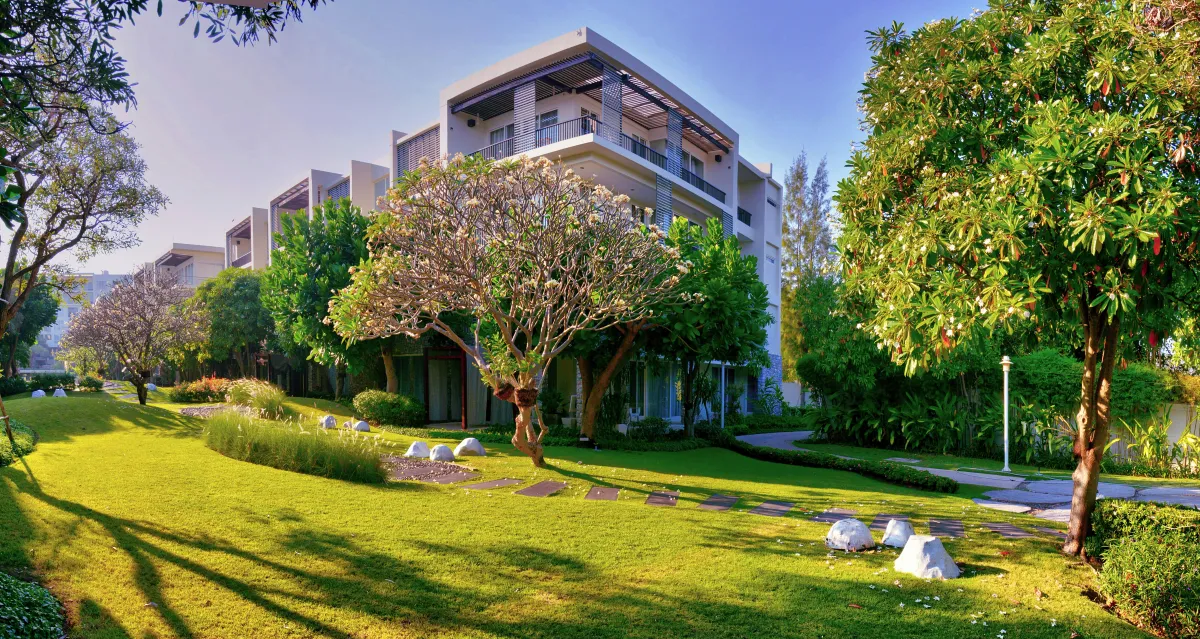 apartment building in a grassy field area