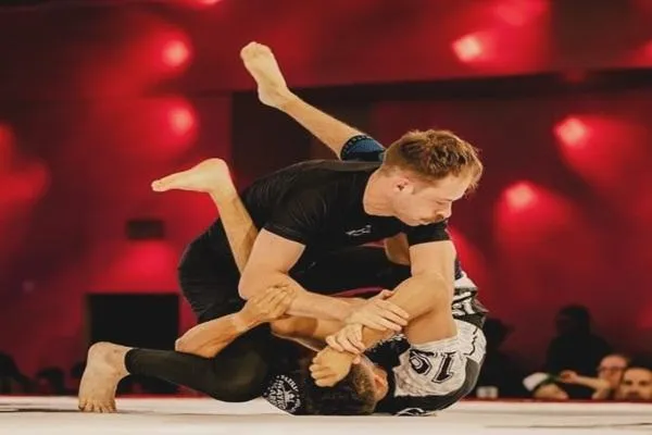 Dylan Sage Knostman showcasing grappling techniques during a high-intensity match, demonstrating endurance and combat cardio in action.