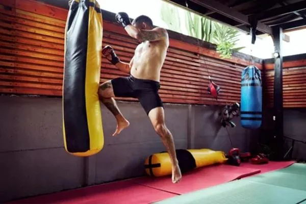Brazilian Jiu-Jitsu training session with fighters practicing grappling techniques on the mat.