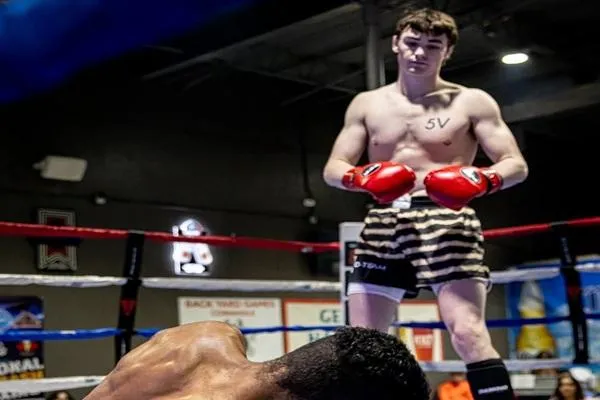 Sam Dalton delivers a powerful body kick during an Apex Fight League bout, showcasing precision and determination in the ring.