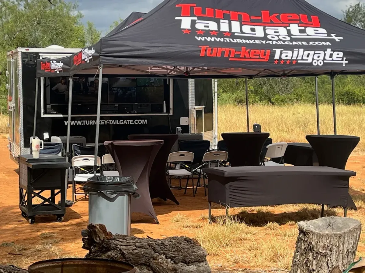 person watching TV In front of a tailgate trailer