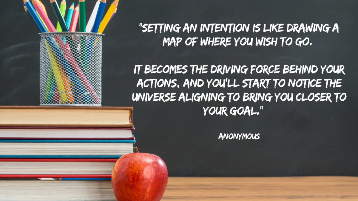 A teacher's desk with books and a chalkboard with a mindfuness quote written on it.