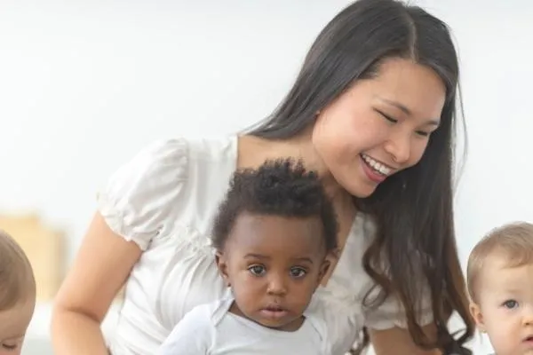a woman babysitting 3 toddlers
